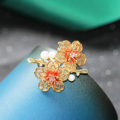 Orange floral brooch