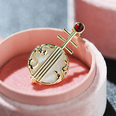 Natural shell musical instrument brooch
