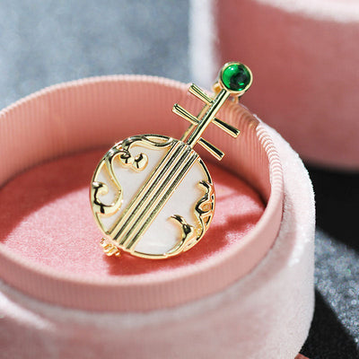 Natural shell musical instrument brooch