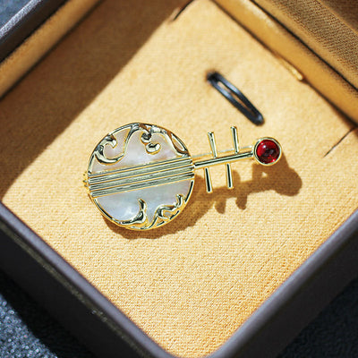 Natural shell musical instrument brooch